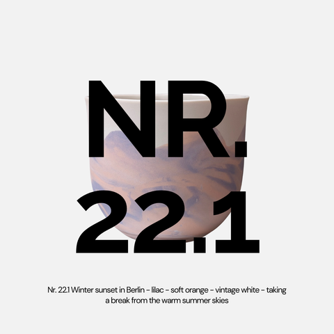Porcelain cup in lilac and orange marbled effect with text 'NR. 22.1' on a white background