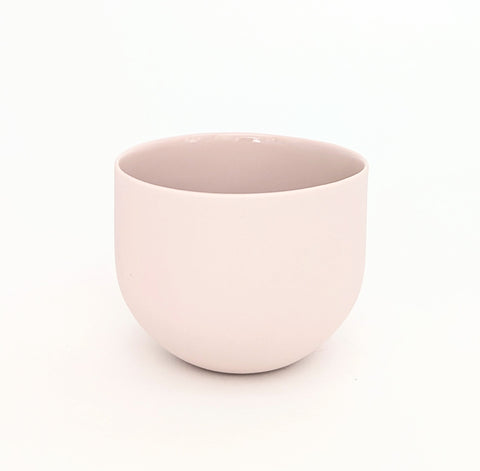 Pink porcelain coffee cup on a white background. Handmade in Berlin.