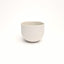 Vintage white porcelain coffee cup on a white background. Handmade in Berlin.