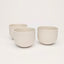 Vintage white porcelain coffee cups on a white background. Handmade in Berlin.
