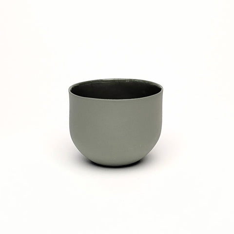 Sage green olive porcelain coffee cup on a white background. Handmade in Berlin.
