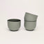 Sage green olive porcelain coffee cups on a white background. Handmade in Berlin.