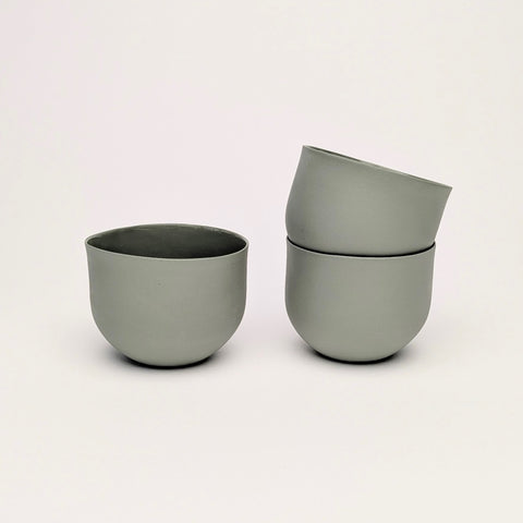 Sage green olive porcelain coffee cups on a white background. Handmade in Berlin.